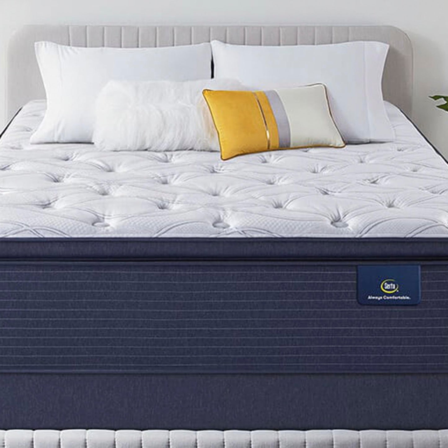 The Serta Classic Elite Plush Pillow Top 15" on a tan bed in a bedroom