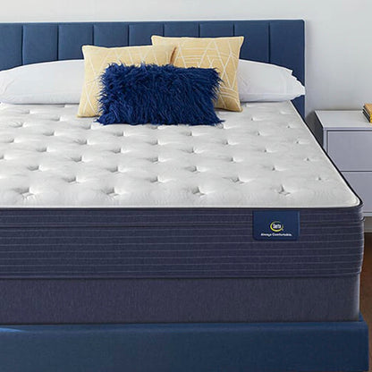 The Serta Classic Plush EuroTop 11.5" on a blue bed, in a bedroom next to a white table