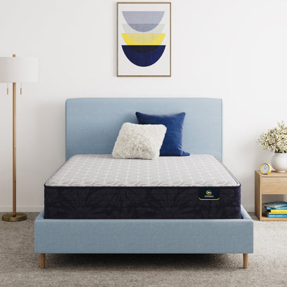 Serta Classic Clarks Hill Mattress on a bed with a blue headboard in a room setting
