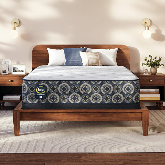 Serta Perfect Sleeper medium mattress on a wooden bed frame with pillows in a bedroom setting