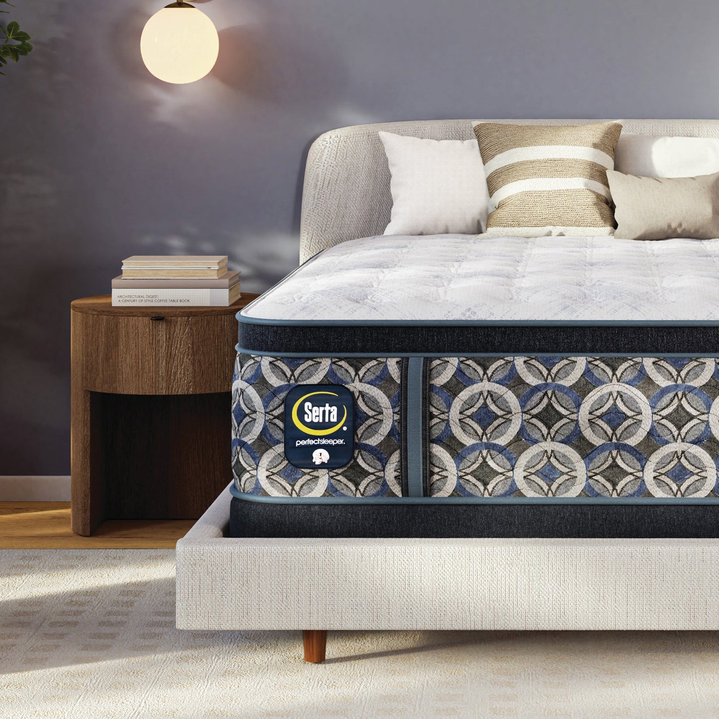 Serta perfect sleeper firm mattress with decorative cover on a bed in a bedroom setting