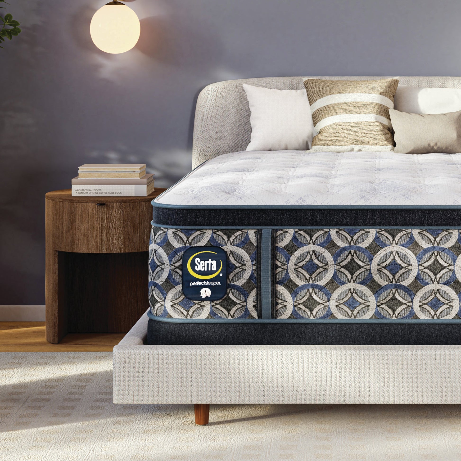Serta perfect sleeper firm mattress with decorative cover on a bed in a bedroom setting