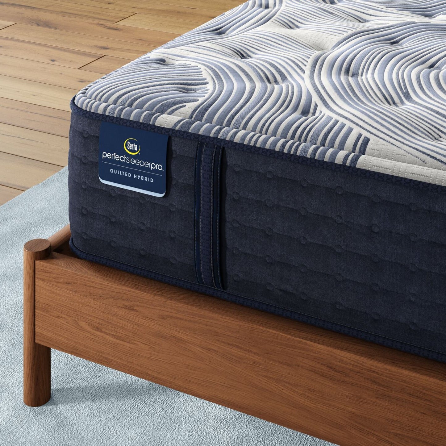 Corner of Perfect Sleeper Pro Dublin Medium mattress sitting in a brown bedframe || Level: Level 2 || Feel: Medium
