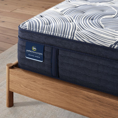 Corner of Perfect Sleeper Pro Edinburgh Plush Pillow Top mattress sitting in a brown bedframe || Level: Level 2 || Feel: Plush Pillow Top
