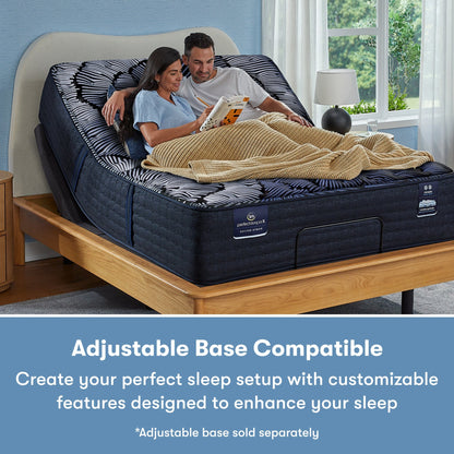 Man and woman sitting in a Perfect Sleeper X Quilted Hybrid Max Firm Pillow Top Mattress sitting in an adjustable base frame || feel: Firm Pillow Top || level: Level 2
