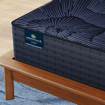 Corner of Perfect Sleeper X Hybrid Prescot Medium Firm Mattress sitting in a brown bedframe || feel: Medium Firm || level: Level 2