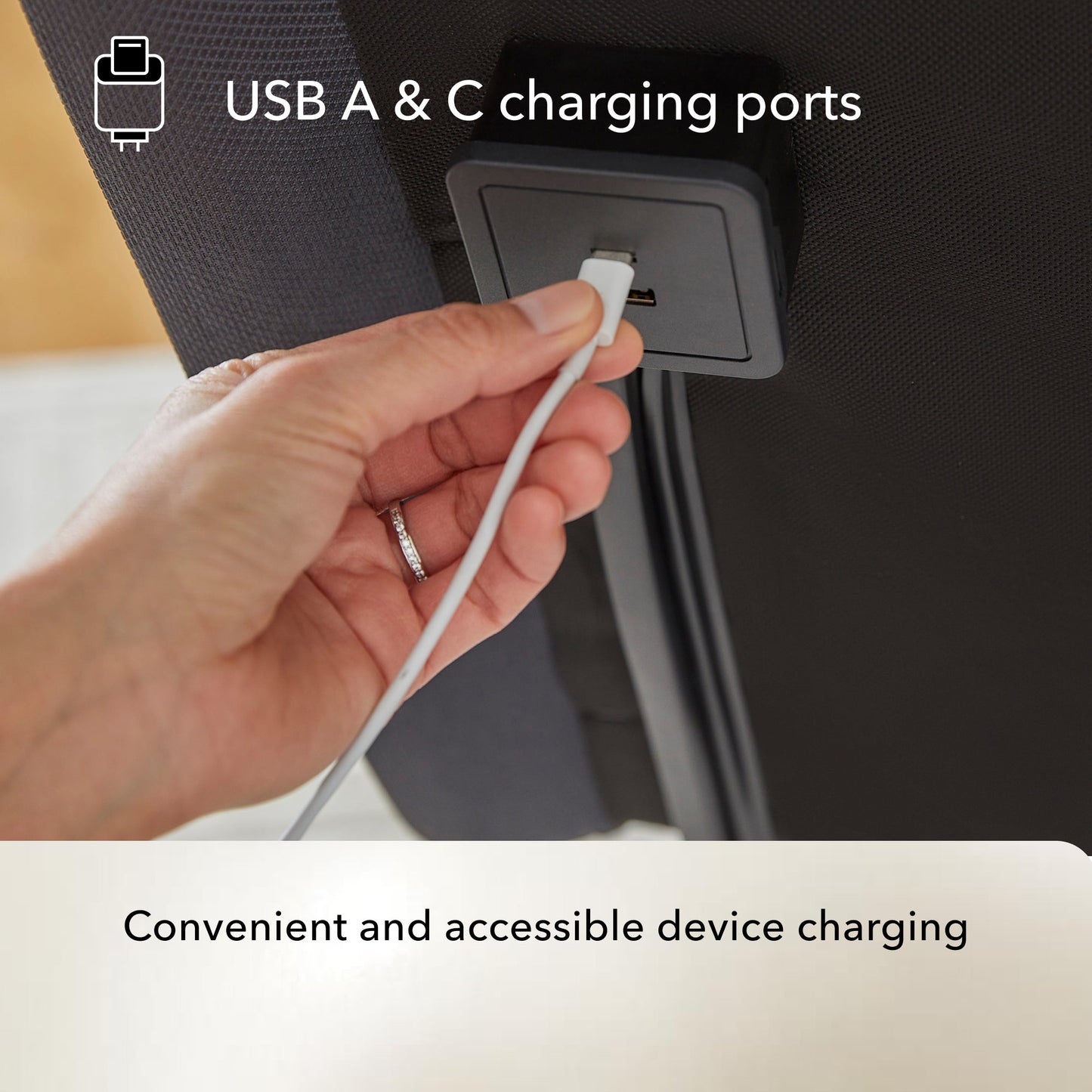Hand plugging a USB cable into a Baselogic Pearl adjustable base USB A & C charging port.