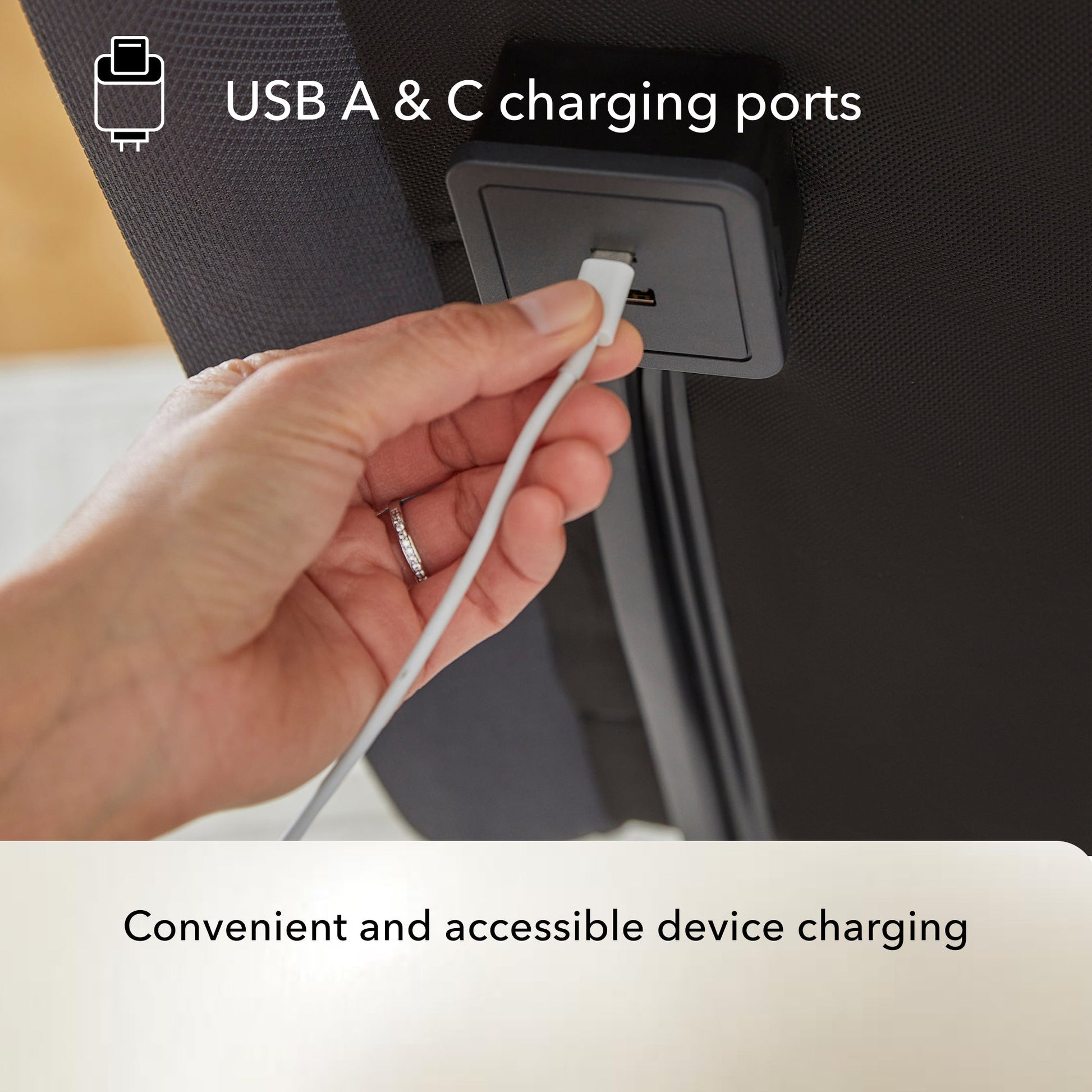 Hand plugging a USB cable into a Baselogic Pearl adjustable base USB A & C charging port.