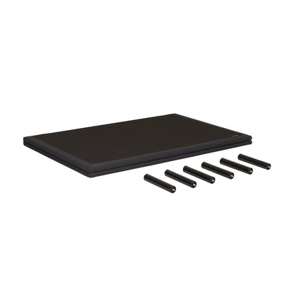 A black rectangular mat or pad shown on a plain white background, with five black cylindrical pieces placed in front of it.