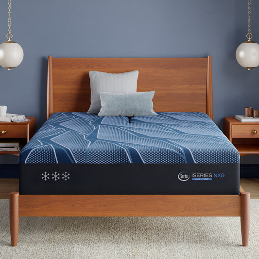 Blue Serta® iSeries® NXG™ mattress with a visible brand logo on a wooden bed frame in a bedroom setting.