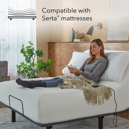 Woman sitting in a Baselogic Bronze Adjustable Base with a white mattress on top of it.